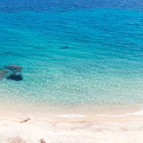 Spend the day at Psarou beach – it's eight minutes away by car