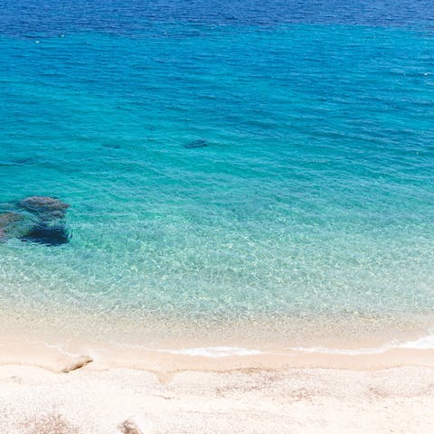 Spend the day at Psarou beach – it's eight minutes away by car