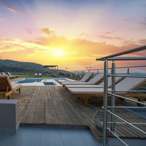 Admire the sunset by the poolside