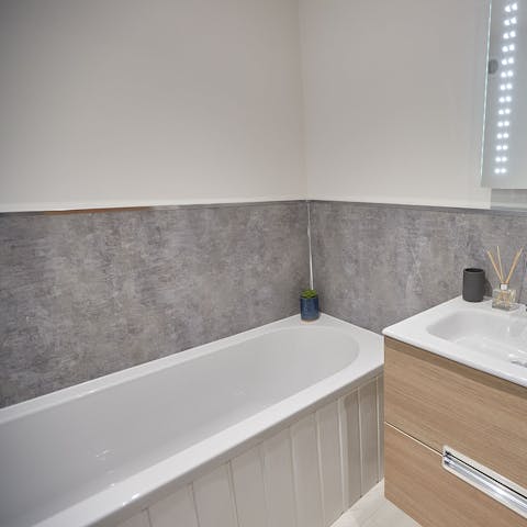 Run yourself a steamy bath in the home's sleek tub
