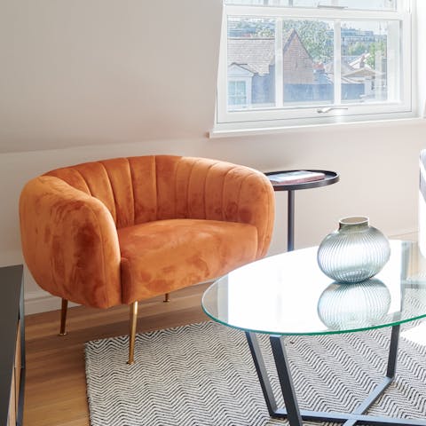 Sip an Earl Grey in the morning on the plush, orange armchair