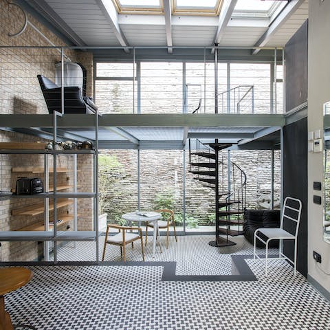 Relax in an industrial-chic living space with high ceilings and natural light