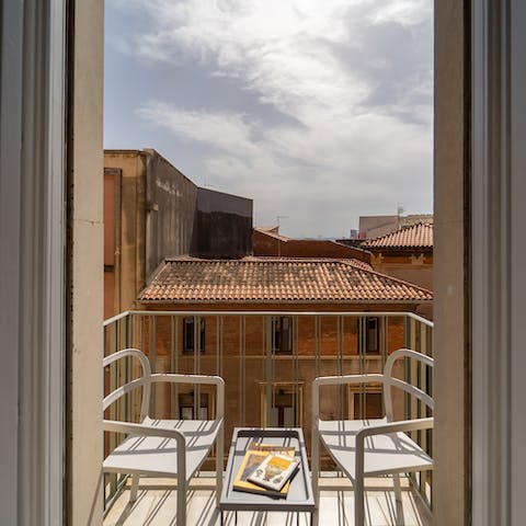 Enjoy a glass of Italian wine on the private balcony at sunset