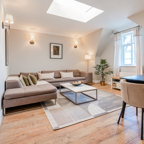 Relax beneath the living room's skylight, a glass of wine in hand