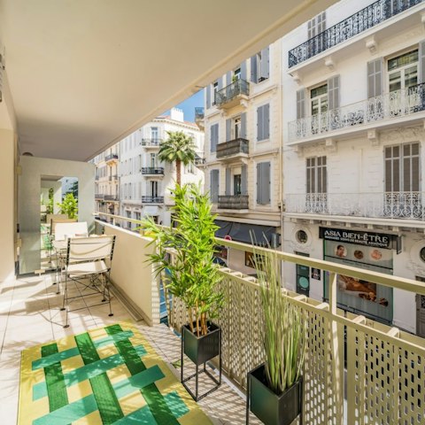 Take in the views over the grand French architecture from the balcony