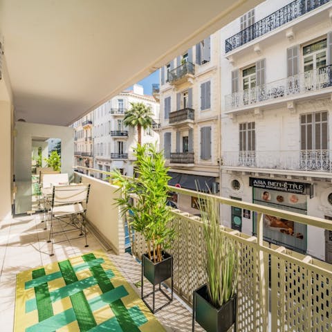 Take in the views over the grand French architecture from the balcony