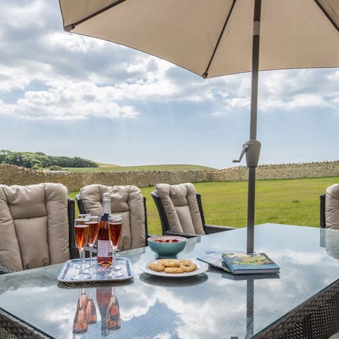 Dine alfresco and enjoy the view over clotted cream and scones
