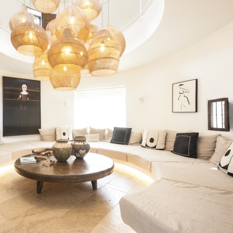 Gather together on the stylish curved sofa for a movie night in