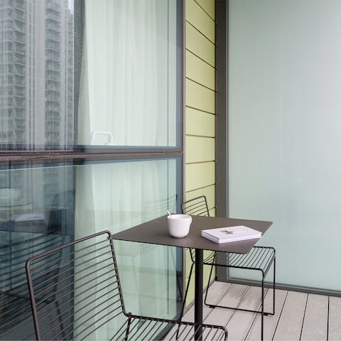 Sit out on the home's balcony and enjoy sweeping views of London's business district