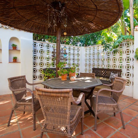 Sip a fresh cocktail under the wicker parasol