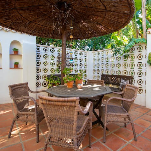 Sip a fresh cocktail under the wicker parasol