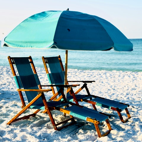 Stroll to the beach where deckchairs and an umbrella are waiting