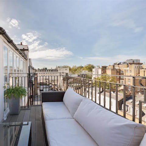 Admire the views from the private terrace, a glass of wine in hand