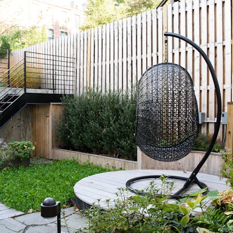 A rattan swing chair in the garden