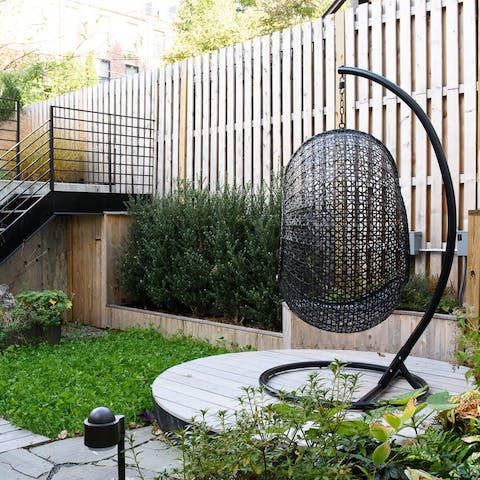 A rattan swing chair in the garden