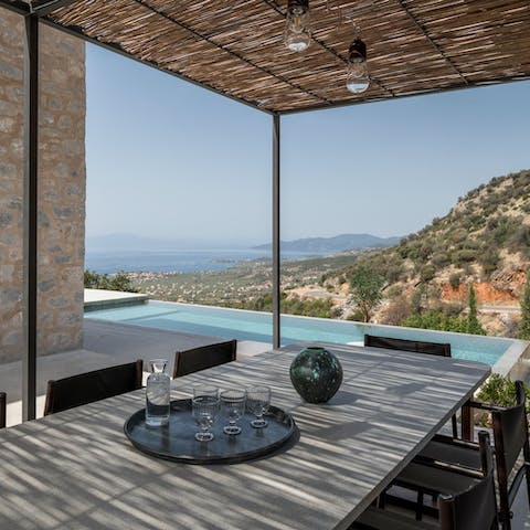 Share an array of Greek mezze under the pergola