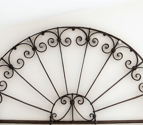 The wrought-iron headboard