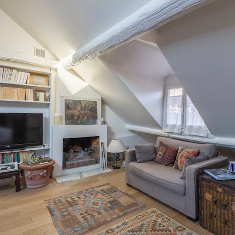 Cosy up by the charming fireplace