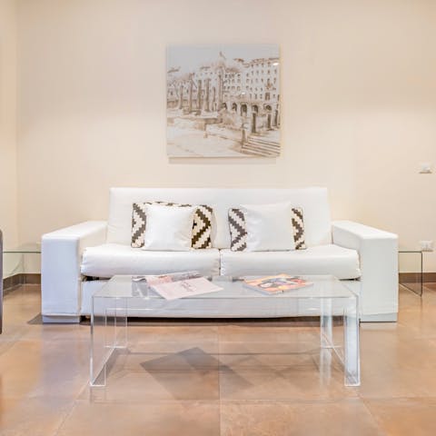 Kick back and relax on the cushy white sofa – it also doubles as a sofa bed