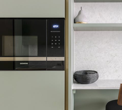 The olive-green kitchen cabinets