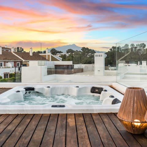 Watch the sun set while soaking in the hot tub