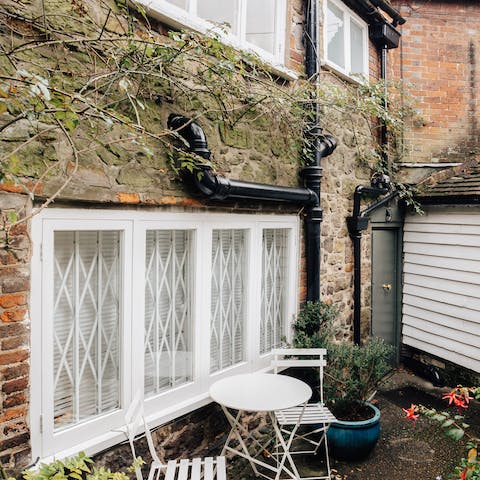 Relax with a cup of tea in the compact courtyard garden