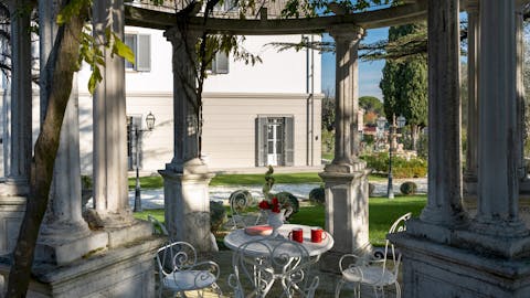 Sip your morning coffee under the stone gazebo as the scent of wisteria drifts by