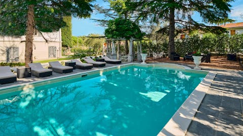Recline poolside, getting lost in a good novel as you listen to the trickle of the water fountain