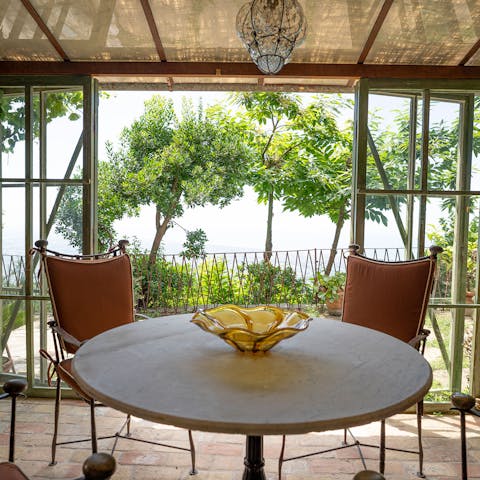 Enjoy a glass of Prosecco at sunset in the conservatory dining room