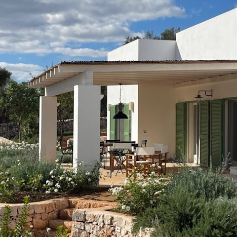 Dine alfresco surrounded by typical Puglian greenery