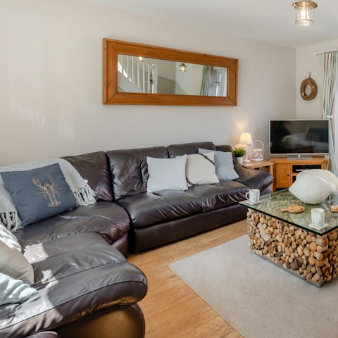 Enjoy a warm welcome from the cosy living room