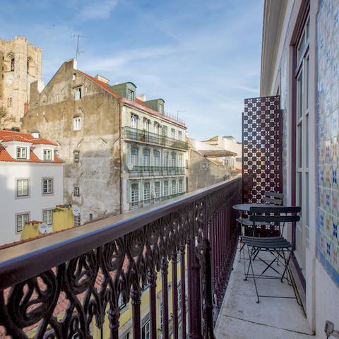 Relax with a glass out on the cosy balcony as the hum of Lisbon life goes on around you