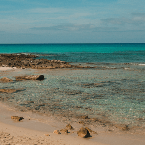 Head to Benirrás Beach, a ten-minute drive away