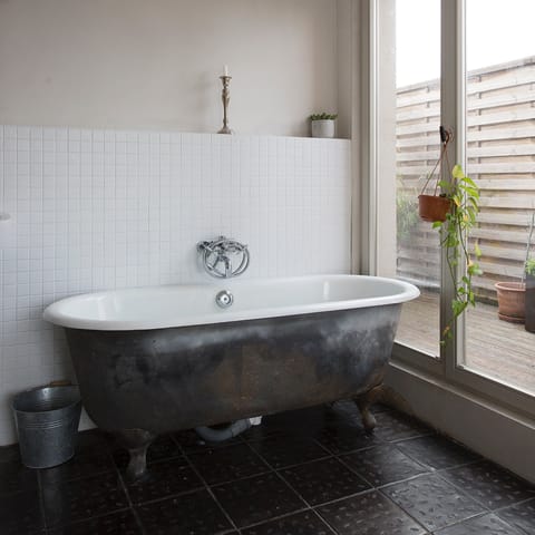 Soak in the free-standing bathtub