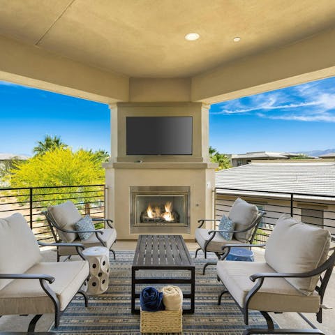 Relax on the terrace with its outdoor fireplace and TV