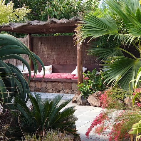 Find one of the many hidden nooks to relax in among the lush greenery of the garden