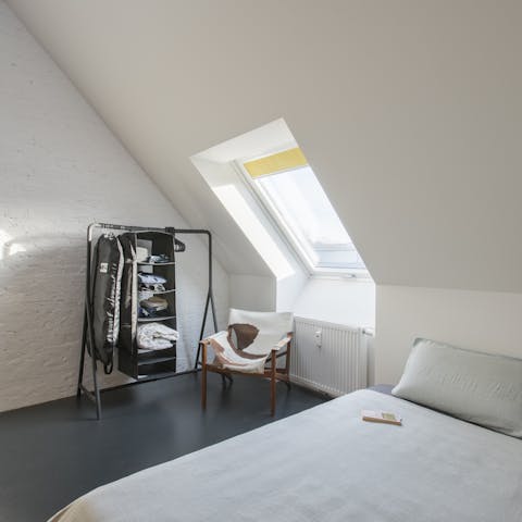 Wake up to stunning city vistas from the bedroom's slanted window