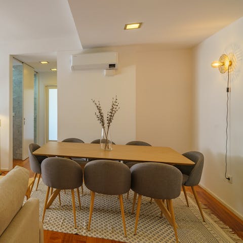 Gather around the sleek wooden table for a family feast of Portuguese dishes