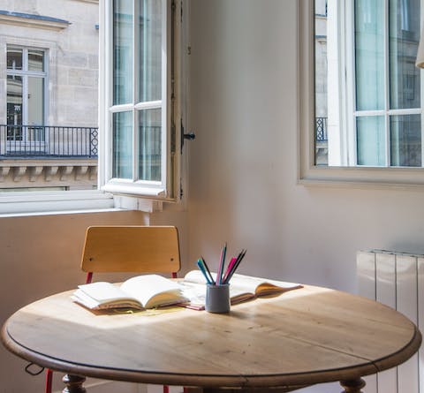 Find a sunny spot around the wooden dining table for two