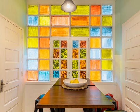 Eat breakfast beside the decorative stained glass window