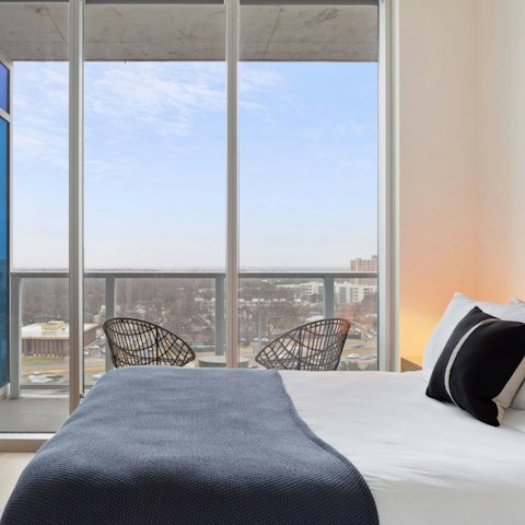 Wake up to cityscape views through floor-to-ceiling windows