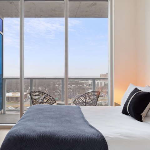 Wake up to cityscape views through floor-to-ceiling windows