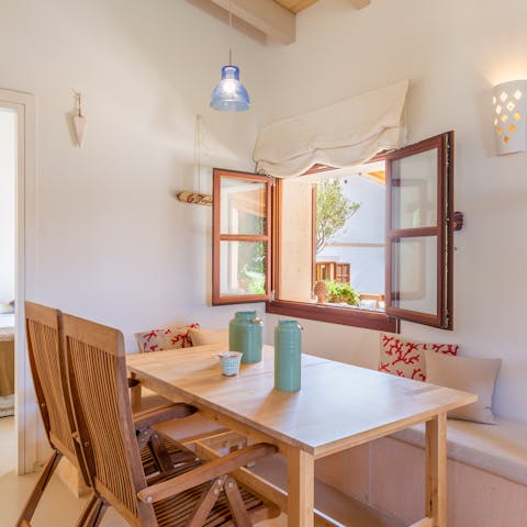 Start mornings with breakfast at the cosy table as you relish the sea breeze coming through the window