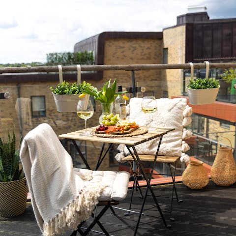Enjoy a glass of wine and a few snacks on the balcony
