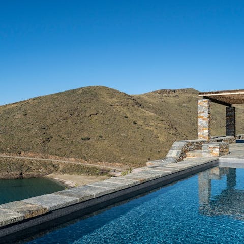 Cool down in the infinity pool overlooking the amazing turquoise Aegean sea