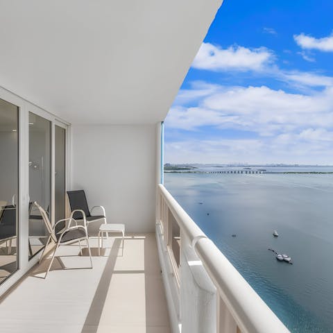 Toast the sunset with drinks on the balcony