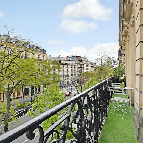 Enjoy a glass of Champagne on the balcony overlooking this typically Parisian street