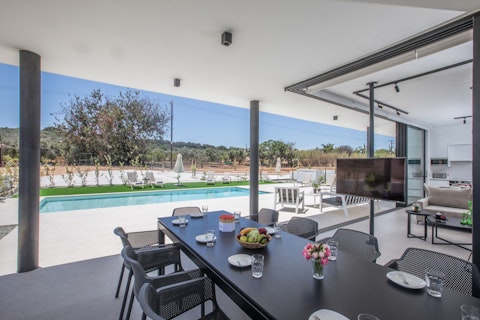 Dine outside with the pool and olive groves ahead