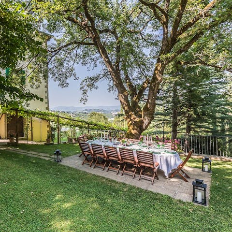 Gather for magical evening meals under the Tuscan trees
