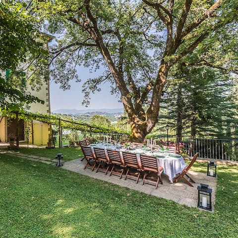 Gather for magical evening meals under the Tuscan trees